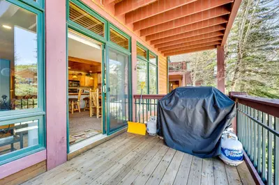 a porch of a house with a cover on it at Walk to Gondola Condo with Deck in Winter Park! in Winter Park