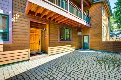 a wooden house with a porch and a balcony at Walk to Gondola Condo with Deck in Winter Park! in Winter Park
