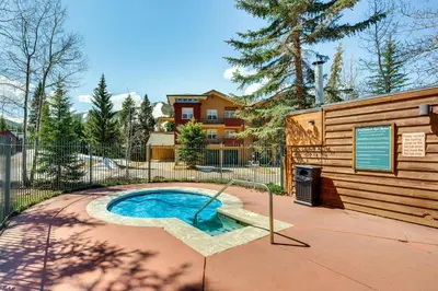 a small pool in a yard next to a building at Walk to Gondola Condo with Deck in Winter Park! in Winter Park