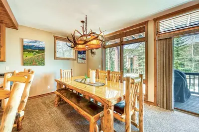 a dining room with a wooden table and chairs at Walk to Gondola Condo with Deck in Winter Park! in Winter Park