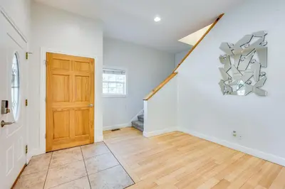 a room with a staircase and a wooden door at 2 Mi to Lake Estes Home with Deck and Grill in Estes Park