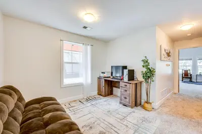 a living room with a couch and a desk at 2 Mi to Lake Estes Home with Deck and Grill in Estes Park