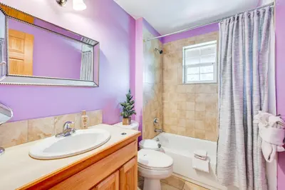 a bathroom with purple walls and a sink and a toilet at 2 Mi to Lake Estes Home with Deck and Grill in Estes Park