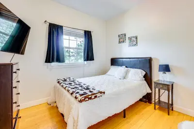 a bedroom with a bed and two windows at 2 Mi to Lake Estes Home with Deck and Grill in Estes Park