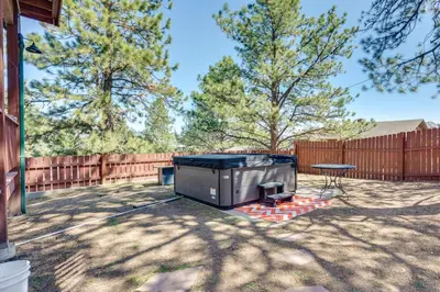 a backyard with a barbecue grill and a table at 2 Mi to Lake Estes Home with Deck and Grill in Estes Park