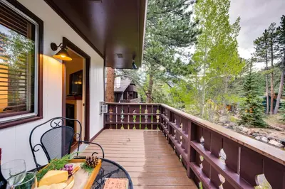 a balcony of a house with a table and chairs at Estes Park Condo Rental Balcony with River Views! in Estes Park