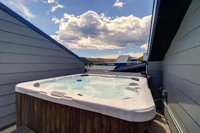 a hot tub sitting on the side of a house at 58B 2Br 2,5Ba townhouse in Silverthorne