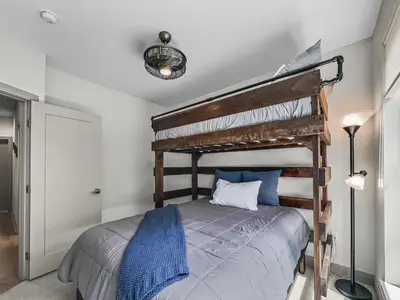 a bedroom with a wooden bunk bed with blue sheets at 58B 2Br 2,5Ba townhouse in Silverthorne