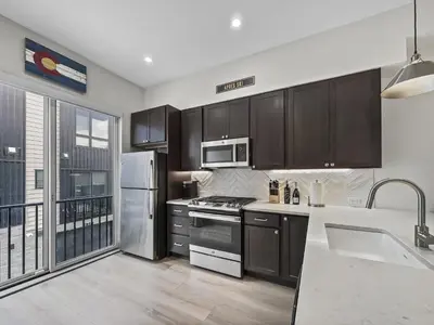 a kitchen with stainless steel appliances and wooden cabinets at 58B 2Br 2,5Ba townhouse in Silverthorne