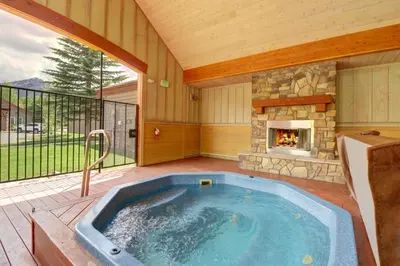 a hot tub in a patio with a fireplace at E8 Drake Landing 2Br Loft condo in Frisco