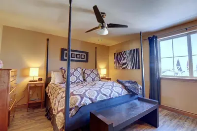 a bedroom with a bed and a ceiling fan at E8 Drake Landing 2Br Loft condo in Frisco