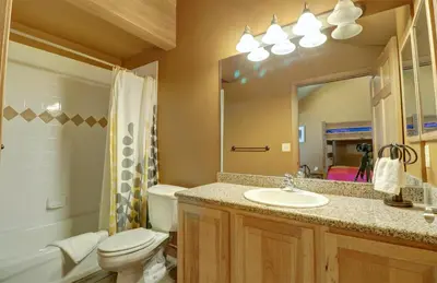 a bathroom with a toilet and a sink and a mirror at E8 Drake Landing 2Br Loft condo in Frisco