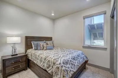 a bedroom with a bed and a window at Clearwater Lofts - 3 Bedroom Luxury Condo Near Lakeside Village in Keystone
