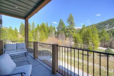 a screened in porch with a couch and a view at Clearwater Lofts - 3 Bedroom Luxury Condo Near Lakeside Village in Keystone