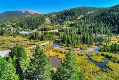 an aerial view of a river in a forest at Clearwater Lofts - 3 Bedroom Luxury Condo Near Lakeside Village in Keystone