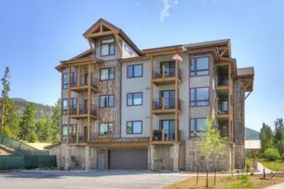 a large apartment building with a garage at Clearwater Lofts Luxury 1 Bed Condo Near Lakeside Village in Keystone