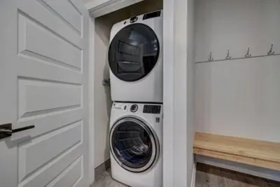 a washer and dryer in a white laundry room at Clearwater Lofts Luxury 1 Bed Condo Near Lakeside Village in Keystone
