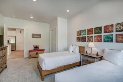 a large bedroom with two beds and a television at Clearwater Lofts - New! Modern 2 Bedroom Near Keystone Lake in Keystone