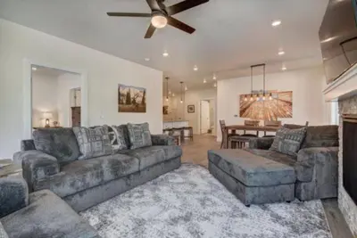 a living room with couches and a dining room at Clearwater Lofts - New! Modern 2 Bedroom Near Keystone Lake in Keystone