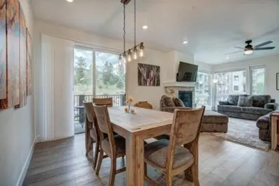 a dining room and living room with a table and chairs at Clearwater Lofts - New! Modern 2 Bedroom Near Keystone Lake in Keystone