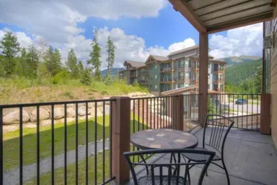 a patio with a table and chairs on a balcony at Clearwater Lofts - New! Modern 2 Bedroom Near Keystone Lake in Keystone