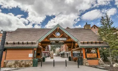 a large wooden building with a sign on it at River Run Village Condos - 2 Bedroom - Walk To Lift! in Keystone