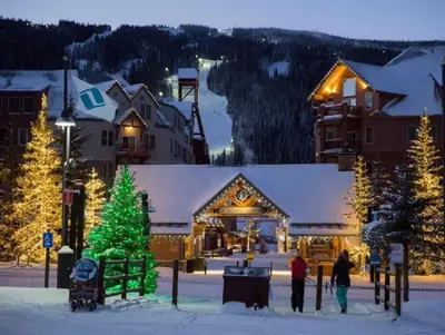 a group of people standing in the snow in front of a lodge at River Run Village Condos - 2 Bedroom - Walk To Lift! in Keystone