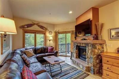 a living room with a couch and a fireplace at River Run Village Condos - 2 Bedroom - Walk To Lift! in Keystone