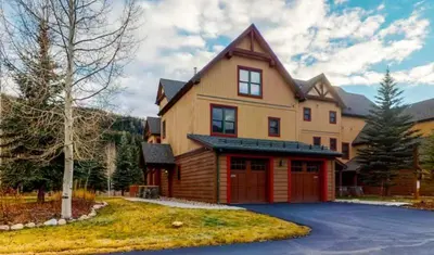 a large house with a red garage at Red Hawk Townhomes 4 Bedroom - 200 Yards To Gondola! in Dillon