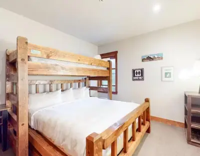 a bedroom with two bunk beds and a dresser at Red Hawk Townhomes 4 Bedroom - 200 Yards To Gondola! in Dillon
