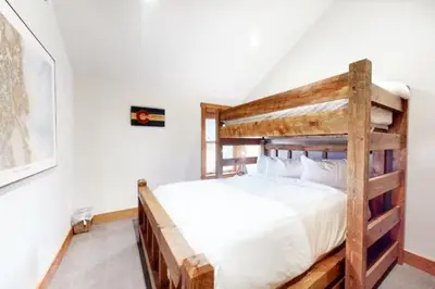 a bedroom with a wooden bunk bed in a room at Red Hawk Townhomes 4 Bedroom - 200 Yards To Gondola! in Dillon