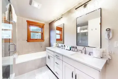 a bathroom with a sink and a tub and a mirror at Red Hawk Townhomes 4 Bedroom - 200 Yards To Gondola! in Dillon