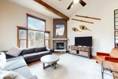 a living room with a couch and a tv at Red Hawk Townhomes 4 Bedroom - 200 Yards To Gondola! in Dillon
