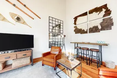 a living room with a tv and a table and chairs at Red Hawk Townhomes 4 Bedroom - 200 Yards To Gondola! in Dillon