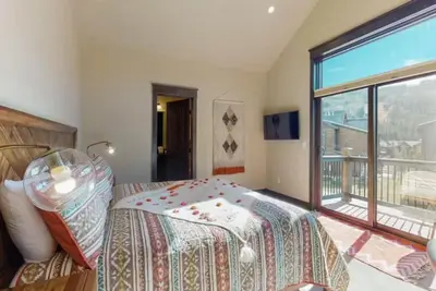 a bedroom with a bed and a large window at River Run Townhomes - 3 Bedroom - Walk To Slopes! in Keystone