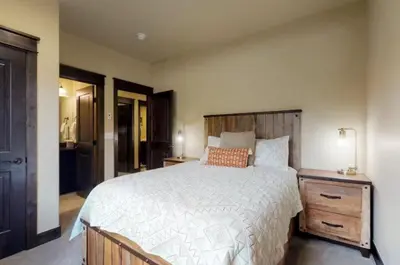 a bedroom with a large bed with a wooden headboard at River Run Townhomes - 3 Bedroom - Walk To Slopes! in Keystone