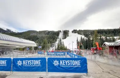 a ski resort with a ski slope in the background at River Run Townhomes - 3 Bedroom - Walk To Slopes! in Keystone