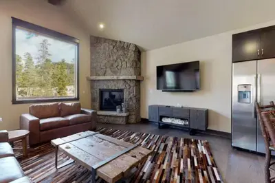 a living room with a couch and a fireplace at River Run Townhomes - 3 Bedroom - Walk To Slopes! in Keystone