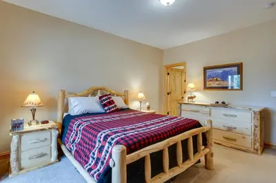 a bedroom with a wooden bed and two dressers at Fraser Vacation Rental 6 Mi to Ski Resort in Fraser