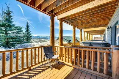 a rocking chair on a deck with a hot tub at Fraser Vacation Rental 6 Mi to Ski Resort in Fraser