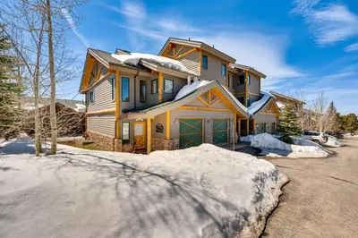 a house is covered in snow in a driveway at Fraser Vacation Rental 6 Mi to Ski Resort in Fraser