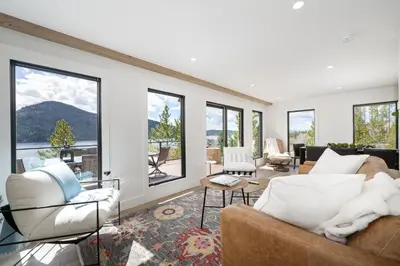 a living room with two couches and windows at Ski Shores cabin in Grand Lake