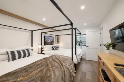 a bedroom with two beds and a television in it at Ski Shores cabin in Grand Lake