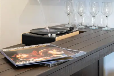 a table with glasses and a record player and a plate at Ski Shores cabin in Grand Lake