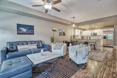 a living room with a couch and chairs and a kitchen at 2 Bedroom townhome, super close to downtown FC! in Fort Collins