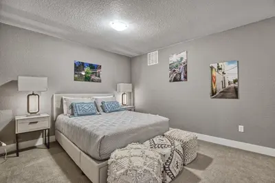 a bedroom with a bed and a table with a lamp at 2 Bedroom townhome, super close to downtown FC! in Fort Collins