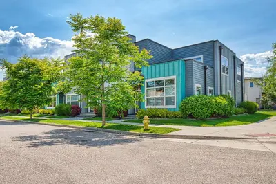 a building with a tree in front of a street at 2 Bedroom townhome, super close to downtown FC! in Fort Collins