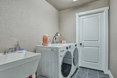 a laundry room with a washing machine and a sink at 2 Bedroom townhome, super close to downtown FC! in Fort Collins