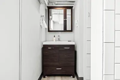 a bathroom with a sink and a mirror at Contemporary Finishes - Studio Apt - Sloans Lake in Denver