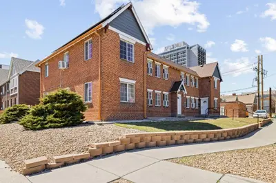 a red brick house with a driveway at Contemporary Finishes - Studio Apt - Sloans Lake in Denver